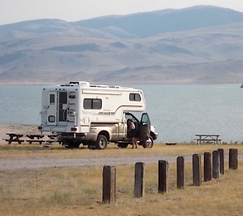 Gold truck with gold-on-white camper